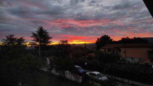 a sunset with cars parked in a parking lot at Natura Affittacamere in Campobasso