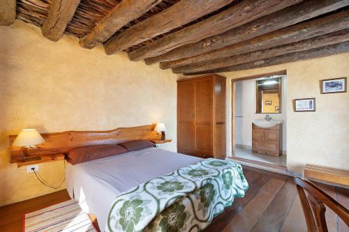 a bedroom with a large bed and a sink at El Lagar in Frontera