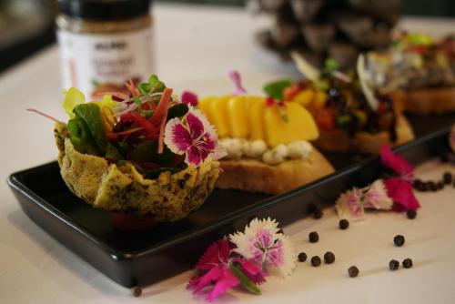 a black plate with some food on a table at Iness Hotel in Łódź