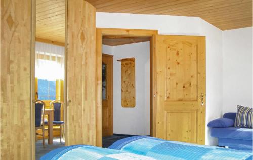 a bedroom with a blue bed and a wooden ceiling at Beautiful Apartment In Kappl With 3 Bedrooms And Wifi in Kappl