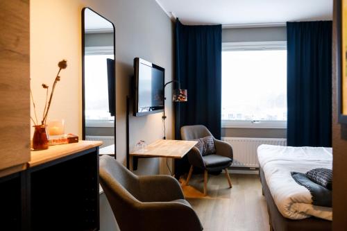 a hotel room with a bed and a mirror at Hotell Nyboholm in Ulricehamn