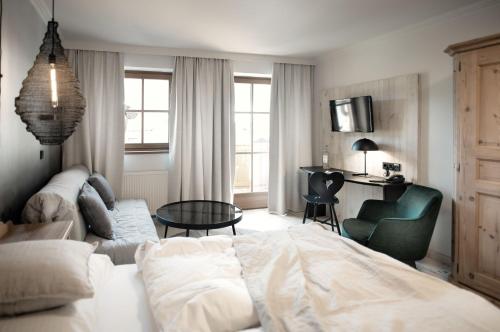 a bedroom with a bed and a couch and a table at Berg-Leben in Grossarl