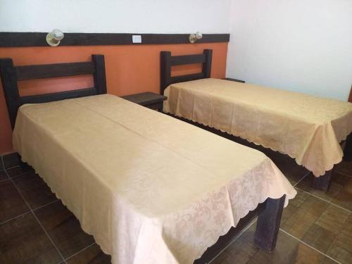 two beds sitting next to each other in a room at Hospedagem para grupos in Piedade