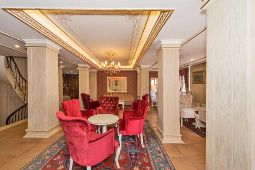 a dining room with red chairs and a table at Santa Sophia Hotel - İstanbul in Istanbul
