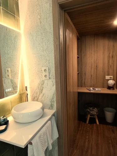 a bathroom with a white sink on a counter at Quinta Padre Lobo in Santa Maria Da Feira