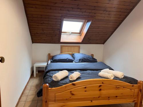 a bedroom with a bed with two towels on it at Appartement duplex in Saint-Louis