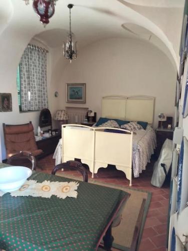 a living room with a bed and a table with a table sidx sidx at Casa Nana' in Carpignano Sesia