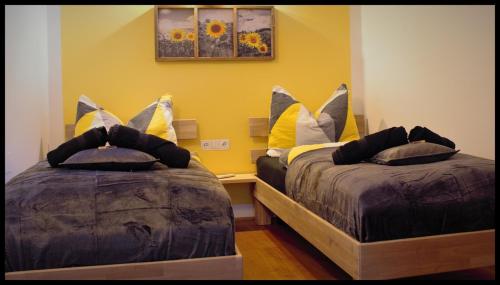 a bedroom with two beds with pillows on them at Apartment Tirol in Kundl