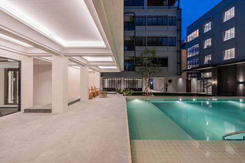 a swimming pool in the middle of a building at Pranakorn Heritage Hotel in Bangkok