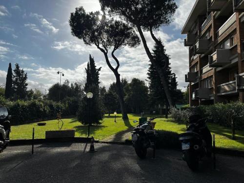 two motorcycles parked in a parking lot next to a building at Aurelia Deluxe Suites in Rome