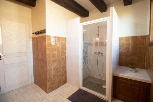 a bathroom with a shower with a glass door at Ferme Bressane - 4 chambres in Saint-Étienne-du-Bois