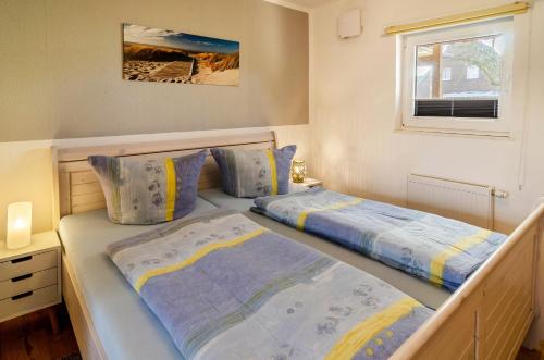 Ένα ή περισσότερα κρεβάτια σε δωμάτιο στο Ferienhaus Diekster - Erdgeschoss 2