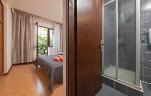 a bedroom with a bed and a glass shower at Sunset Porec 2 in Poreč
