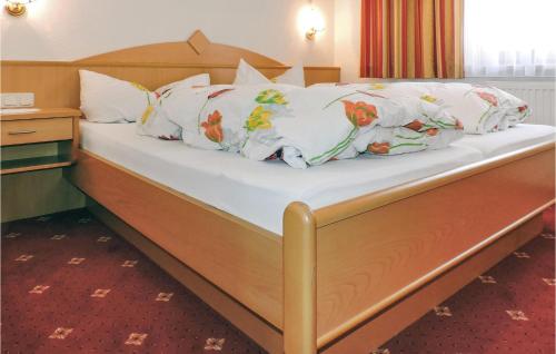 Bett mit weißer Bettwäsche und bunten Kissen in der Unterkunft 1 Bedroom Lovely Apartment In Kappl in Kappl