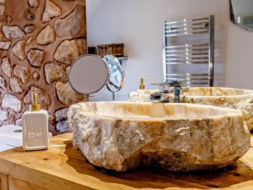 a bathroom with a large rock sink on a counter at 1 Bed in Washford 81240 in Washford