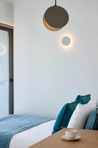 a bedroom with a bed and a table at Twinn Downtown Piraeus, Santikos Collection in Piraeus