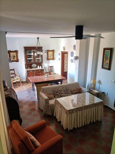 a living room with a couch and a table at Chalet Rafael Constantina in Constantina