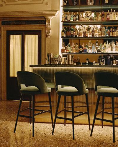 two chairs sitting in front of a bar at Palazzo Keller in Venice