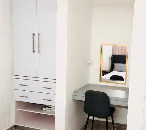 a bedroom with a desk and a mirror and a chair at Studio21-A Centric Comfort Apartment in Bayamon