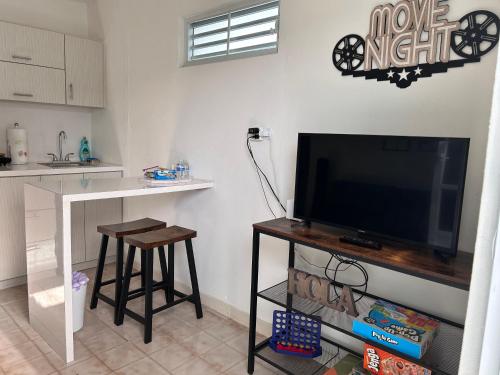 a living room with a flat screen tv on a table at Studio21-A Centric Comfort Apartment in Bayamon