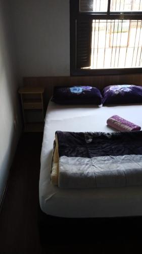 Una cama o camas en una habitación de Pousada AME