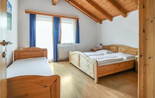 a bedroom with two beds and two windows at Stunning Apartment In Grossarl With 2 Bedrooms And Sauna in Grossarl