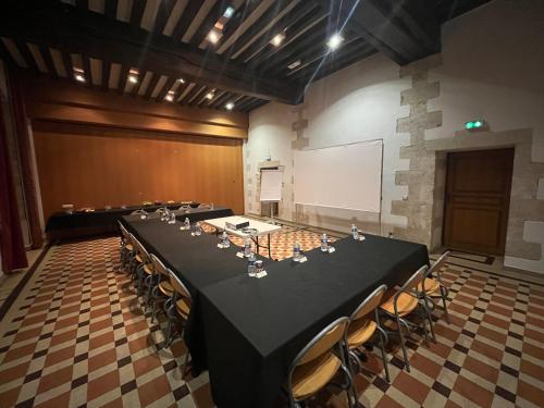a conference room with a long table and chairs at Hôtellerie Saint Yves in Chartres