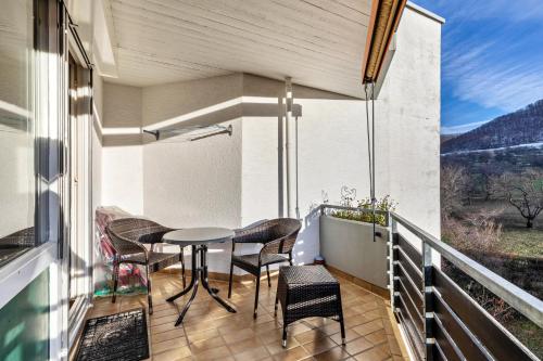 a balcony with a table and chairs and a view at Studti 134 in Beuren