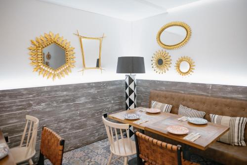 a dining room with a table and mirrors on the wall at MYR Plaza Mercado & Spa in Valencia