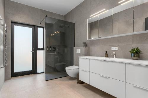 a bathroom with a toilet and a sink and a shower at Luxury Villa in the South - Perfect Location in Ölfus