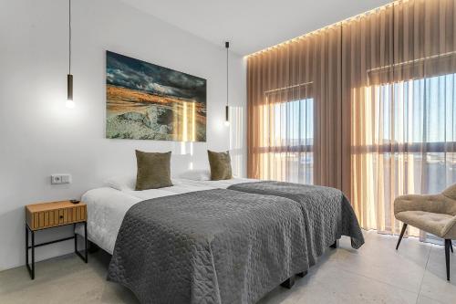 a bedroom with a bed and a large window at Luxury Villa in the South - Perfect Location in Ölfus