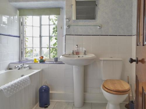 a bathroom with a sink and a toilet and a window at 3 bed in Keswick SZ422 in Applethwaite
