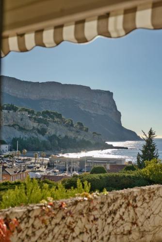 - une vue sur une plage avec une montagne en arrière-plan dans l'établissement Entre Ciel et Mer Appartement Cassis, à Cassis