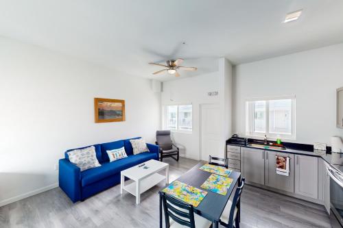 a living room with a blue couch and a table at Ocean Isles 50 in Marathon