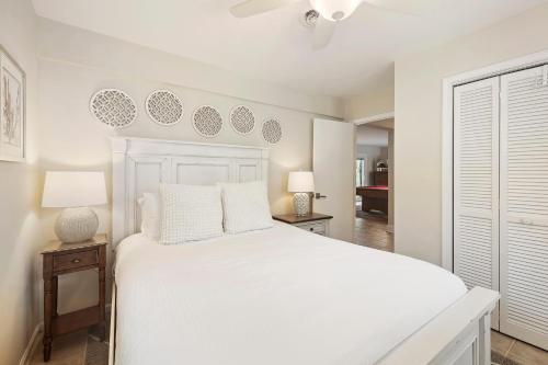 a bedroom with a white bed and two lamps at CA411: 411 Carolina Blvd. in Isle of Palms