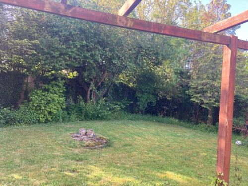 a garden with a wooden structure in the grass at Bluebelle in Bray