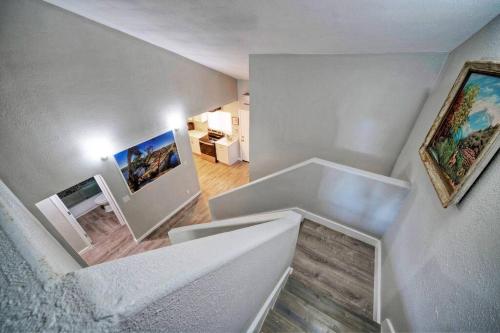 ein weißes Zimmer mit einer Treppe, einem Sofa und Gemälden in der Unterkunft Great Value Stay Near Tesla in Austin