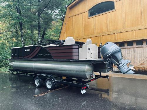 a boat sitting on a trailer next to a building at Osprey Lake Cabin home in Hayward