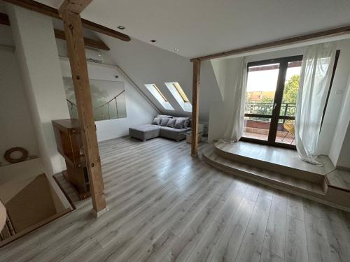 a living room with a staircase and a large window at Apartament Aesthetic in Tychy