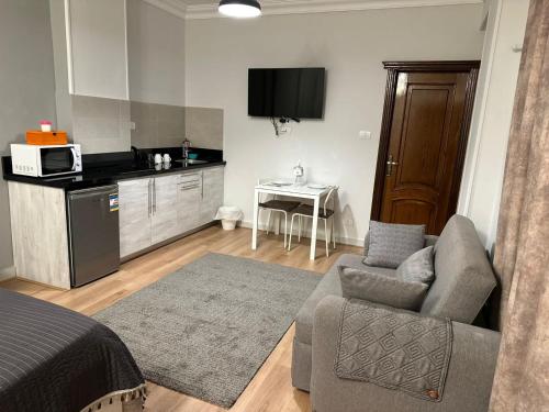 a living room with a couch and a kitchen at Chelay studios in Cairo