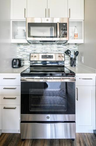a kitchen with a stove and a microwave at Revisn in Raleigh