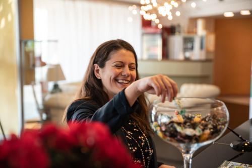 a woman sitting at a table with a bowl of food at Hotel Residence Montelago in Ternate
