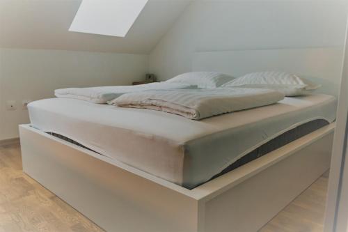 a bed with a raised platform in a room at Špansko view -Comfy apartment in Zagreb