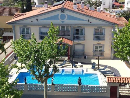 an aerial view of a house with a swimming pool at Hotel Portofino by InsideHome in Empuriabrava