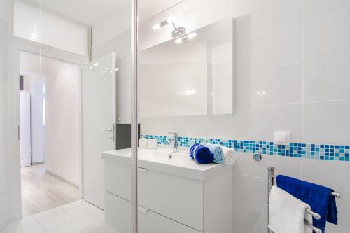 a white bathroom with a sink and a shower at Studio apartment Stella in Labin