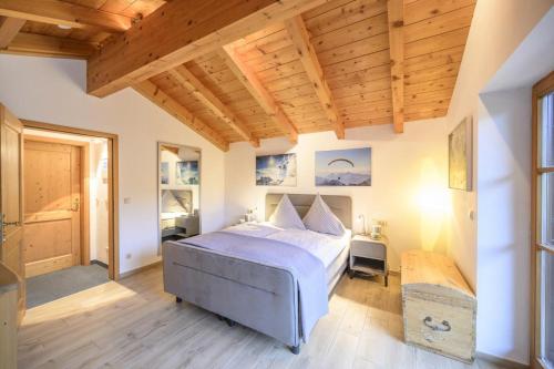 a bedroom with a bed and a wooden ceiling at Ferienhaus Alpenliebe in Grainau in Grainau