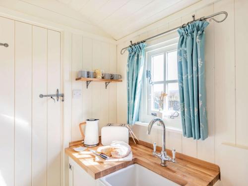 a kitchen with a sink and a window at 1 Bed in Hayfield 87592 in Mellor