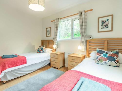 a bedroom with two beds and a window at 2 Bed in Blair Atholl 87927 in Bridge of Tilt