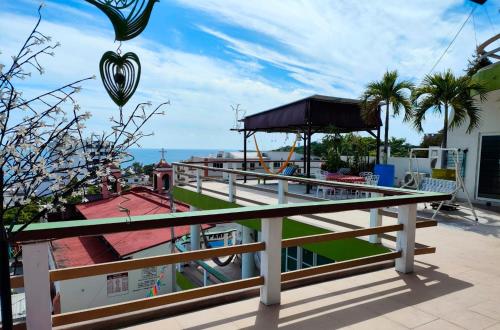 a balcony with a view of the ocean at Casa Mia in Puerto Escondido