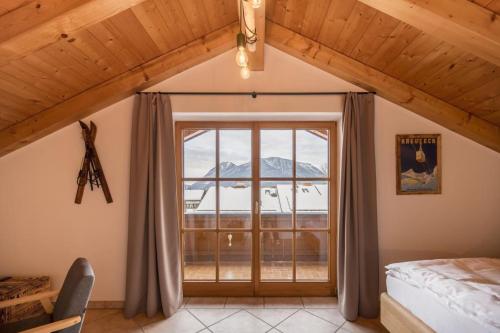 a bedroom with a large window with a mountain view at Ferienhaus Die 12 mit 4 Schlafzimmern in Garmisch in Garmisch-Partenkirchen